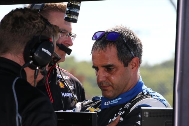 Juan Pablo Montoya chats with his engineers following his qualification session for the INDYCAR Grand Prix at The Glen at Watkins Glen International -- Photo by: Bret Kelley