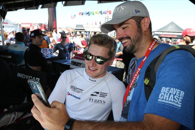 Josef Newgarden poses for a photograph during the autograph session in the INDYCAR Fan Village at Watkins Glen International -- Photo by: Chris Jones