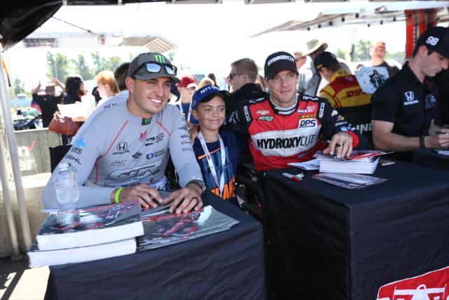 Graham Rahal and Sebastien Bourdais pose for a photograph during the autograph session in the INDYCAR Fan Village at Watkins Glen International -- Photo by: Chris Jones