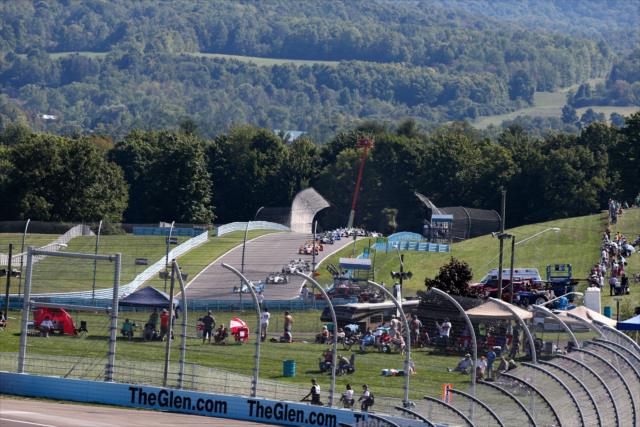 The field streams into Turn 8 during the INDYCAR Grand Prix at The Glen from Watkins Glen International -- Photo by: Bret Kelley