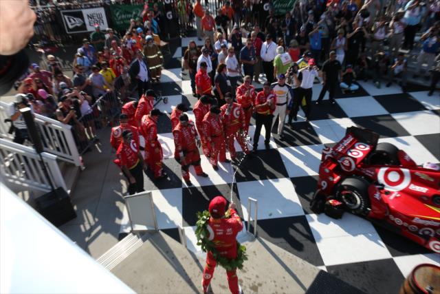 Scott Dixon sprays the champagne toward his Chip Ganassi Racing crew in Victory Lane following their win in the INDYCAR Grand Prix at The Glen from Watkins Glen International -- Photo by: Bret Kelley