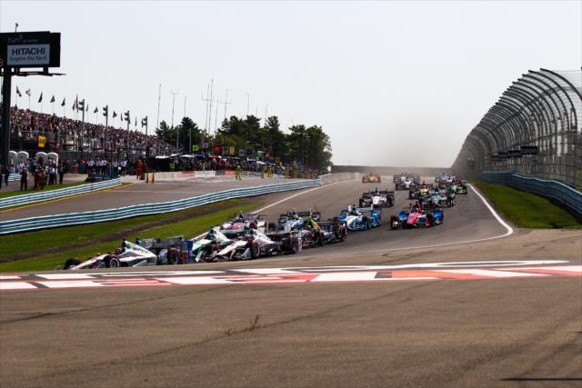 The field dives into Turn 1 at the start of the INDYCAR Grand Prix at The Glen from Watkins Glen International -- Photo by: Bret Kelley