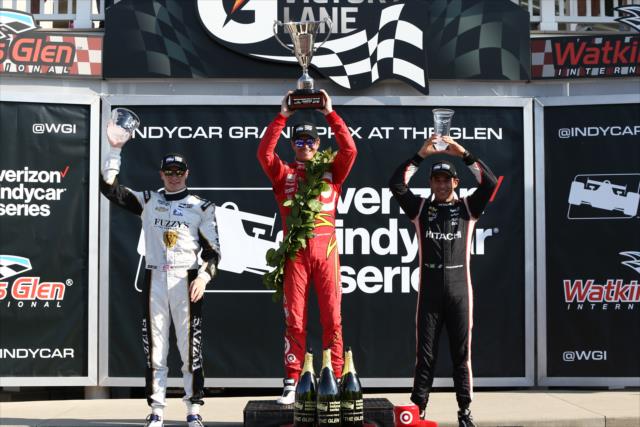 The podium of Scott Dixon, Helio Castroneves, and Josef Newgarden hoist their trophies in Victory Lane following the INDYCAR Grand Prix at The Glen from Watkins Glen International -- Photo by: Chris Jones