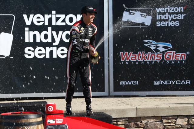 Helio Castroneves sprays the champagne in Victory Lane following the INDYCAR Grand Prix at The Glen from Watkins Glen International -- Photo by: Chris Jones