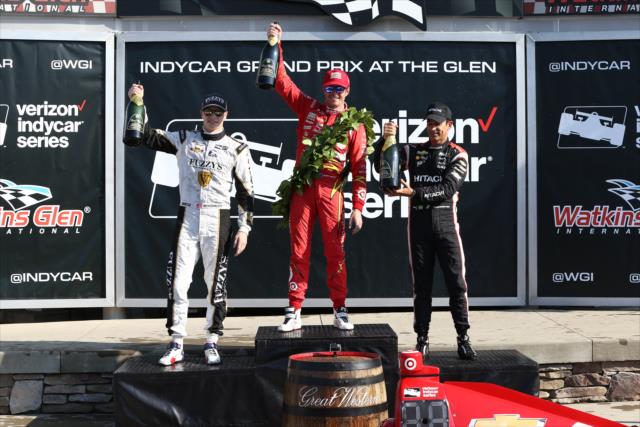The podium of Scott Dixon, Helio Castroneves, and Josef Newgarden hoist their champagne bottles in Victory Lane following the INDYCAR Grand Prix at The Glen from Watkins Glen International -- Photo by: Chris Jones