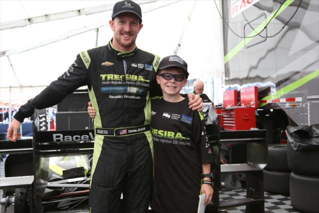 Charlie Kimball meets superfan Zach Schubert in the paddock prior to the final warmup for the INDYCAR Grand Prix at The Glen from Watkins Glen International -- Photo by: Chris Jones