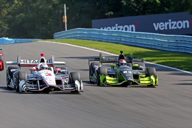 Helio Castroneves and Charlie Kimball set up for Turn 6 during the INDYCAR Grand Prix at The Glen from Watkins Glen International -- Photo by: Mike Harding