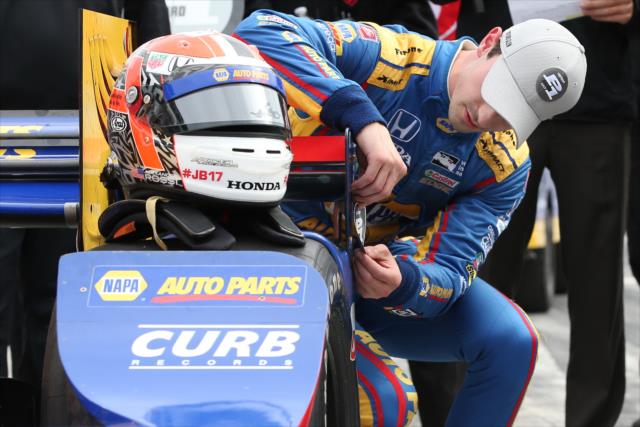 Alexander Rossi affixes the Verizon P1 Award emblem on his machine after winning the pole for the INDYCAR Grand Prix at The Glen from Watkins Glen International -- Photo by: Chris Jones