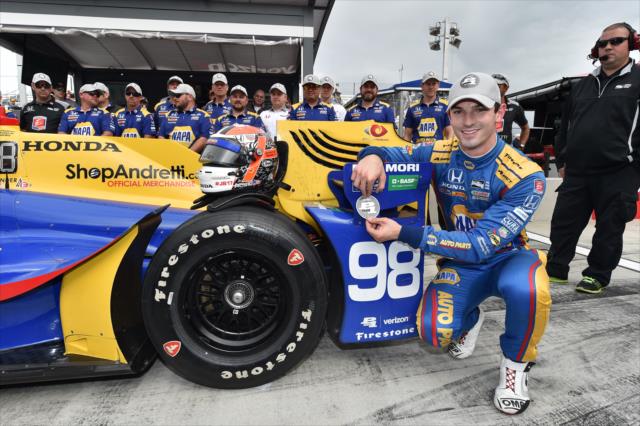 Alexander Rossi affixes the Verizon P1 Award emblem after winning the pole position for the INDYCAR Grand Prix at The Glen -- Photo by: Chris Owens